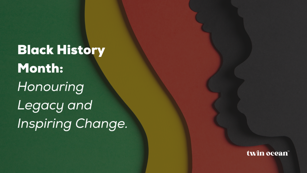 A stylized graphic with layered silhouettes in black, red, green, and gold. White text reads ‘Black History Month: Honouring Legacy and Inspiring Change.’ The Twin Ocean logo is in the bottom right corner.